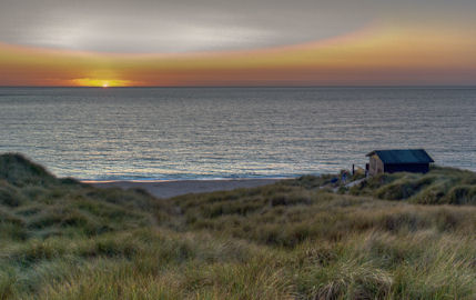 The sun sets over Sennen Cove in Cornwall