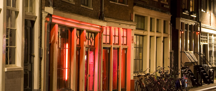 Red lights illuminate the streets of Amsterdam