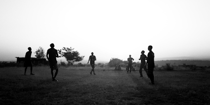 Boys play football in lively downtown Kigali