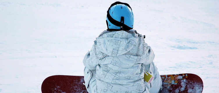 A snowboarder catching their breath