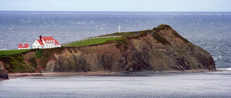 Peninsula with red house on the coast in Quebec