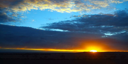 The rising yolk of a desert sunrise